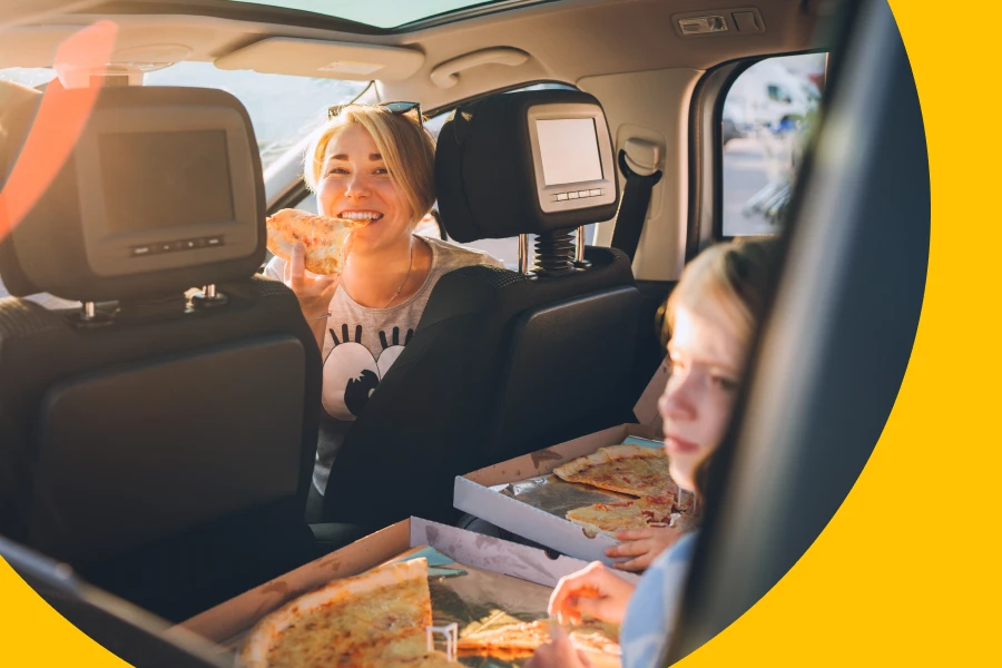 A Woman With Her Passenger Eating a Pizza