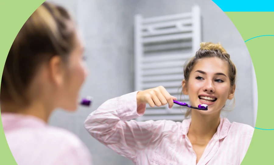 A person brushes her teeth to maintain dental and oral health